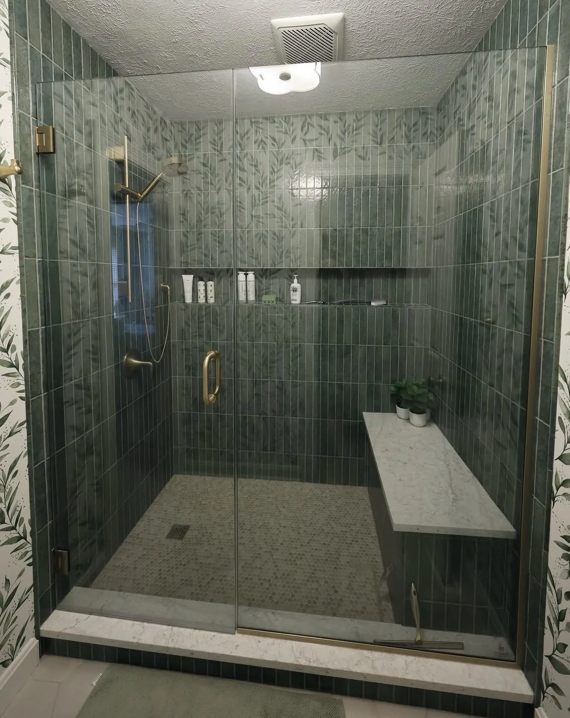Walk In shower with green tile and stone bench that replaced an old tub