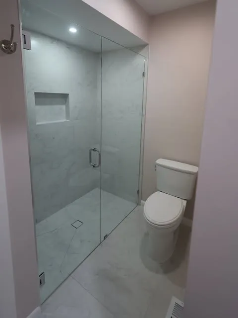 Glass enclosed Walk In shower with floor to ceiling tile