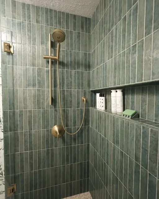 Walk In shower with green tile and clear glass
